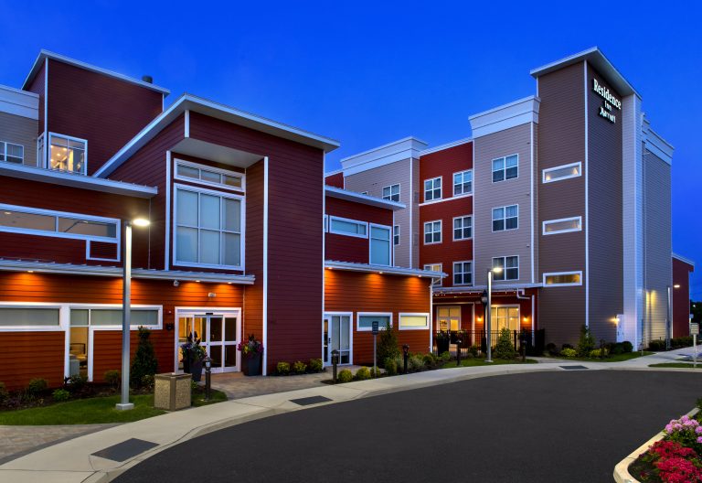 Residence Inn Marriott hotel with red exterior at night.