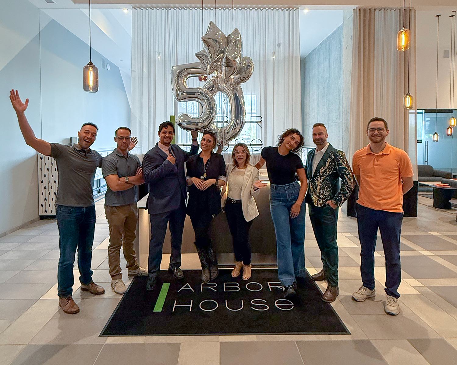 Arbor House is fifty percent leased with team posing in lobby